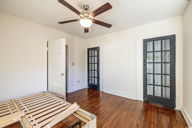 unfurnished bedroom with ceiling fan and dark hardwood / wood-style floors