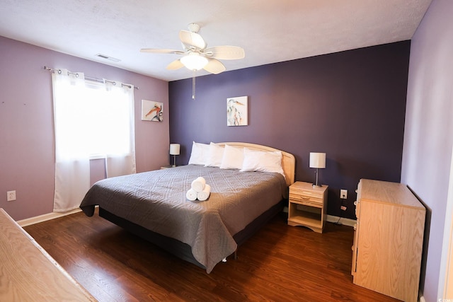 bedroom with ceiling fan and dark hardwood / wood-style flooring