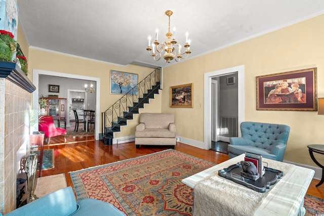 living room with a baseboard heating unit, dark hardwood / wood-style floors, crown molding, and a notable chandelier