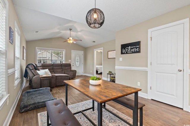 living room featuring vaulted ceiling, wood-type flooring, and ceiling fan