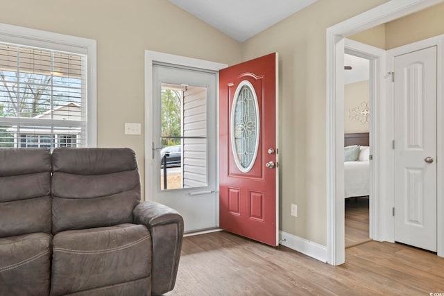 entrance foyer featuring vaulted ceiling and light wood-type flooring