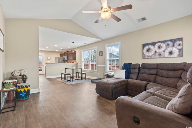 living room with lofted ceiling, hardwood / wood-style floors, and ceiling fan