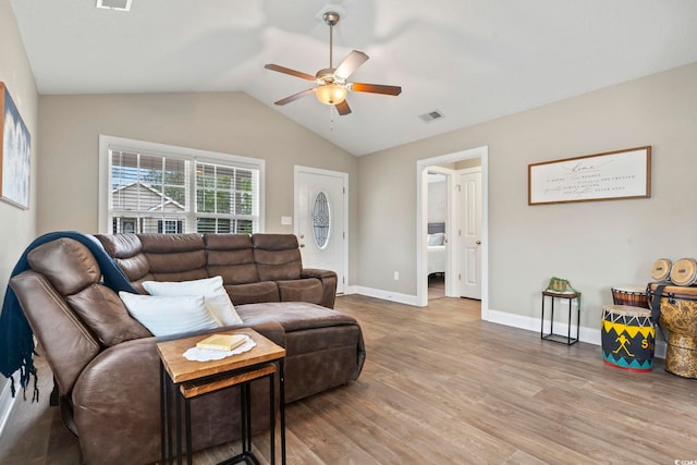 living room with ceiling fan, lofted ceiling, and light hardwood / wood-style floors