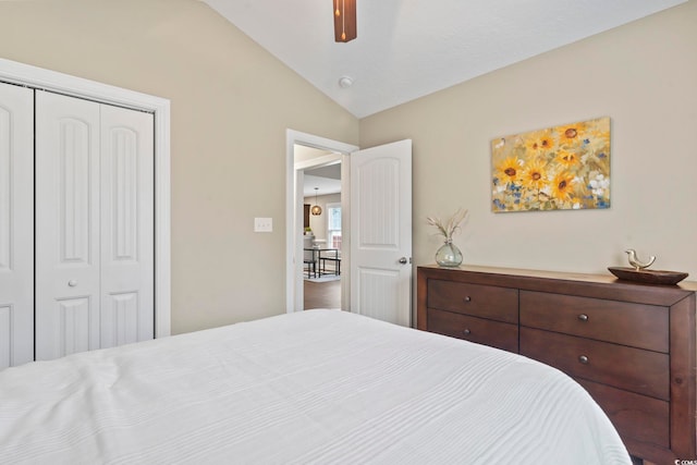 bedroom featuring ceiling fan, lofted ceiling, and a closet