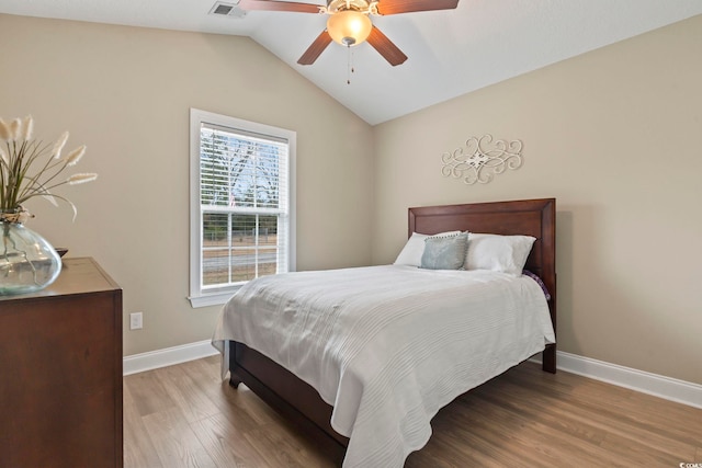 bedroom featuring hardwood / wood-style flooring, vaulted ceiling, and ceiling fan