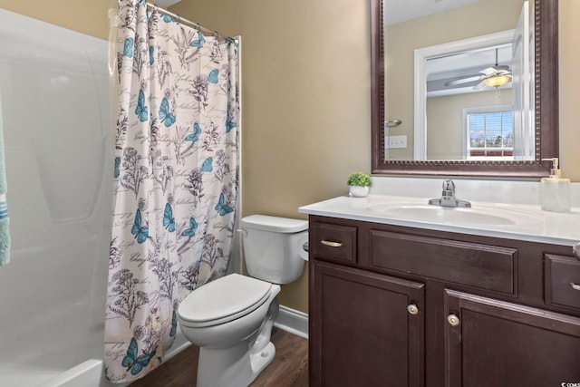 bathroom with hardwood / wood-style flooring, vanity, ceiling fan, and toilet