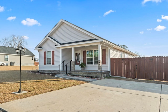 bungalow-style home featuring a porch and a front lawn