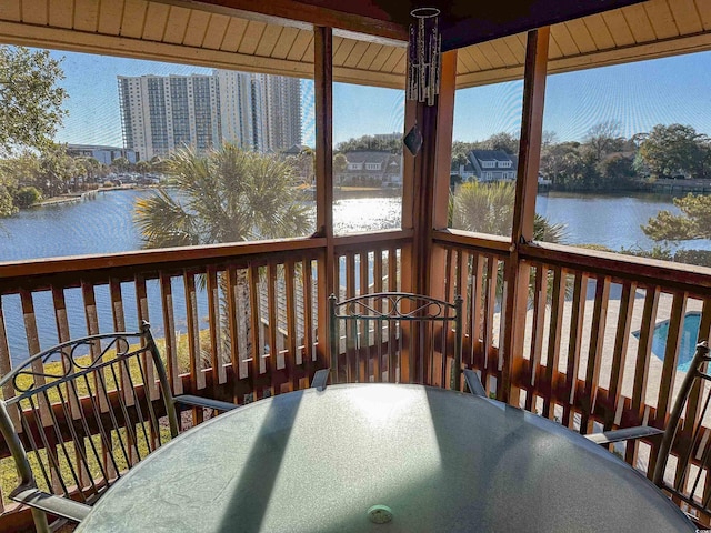 wooden terrace with a water view