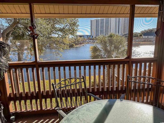 sunroom / solarium with a water view