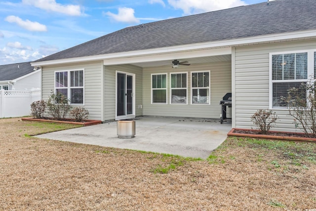 back of house featuring a lawn, a patio area, and ceiling fan