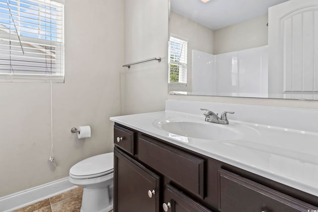 bathroom with tile patterned floors, vanity, toilet, and walk in shower