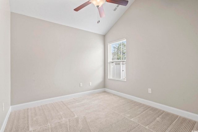 carpeted spare room with ceiling fan and lofted ceiling