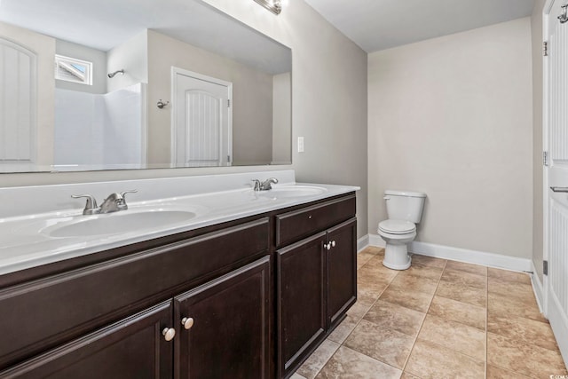 bathroom with vanity, toilet, and walk in shower