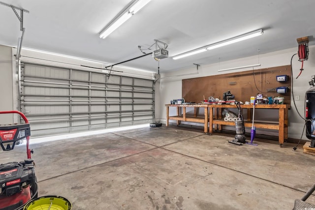 garage with a workshop area and a garage door opener