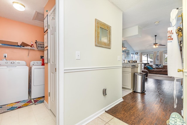 laundry area with washer and dryer, a textured ceiling, light tile patterned floors, and ceiling fan