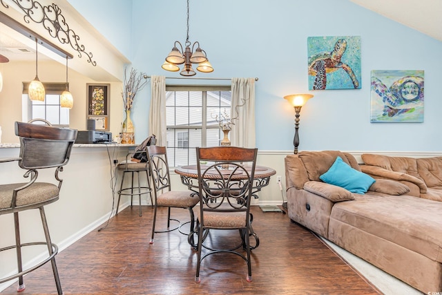 interior space featuring dark hardwood / wood-style flooring, a notable chandelier, and vaulted ceiling