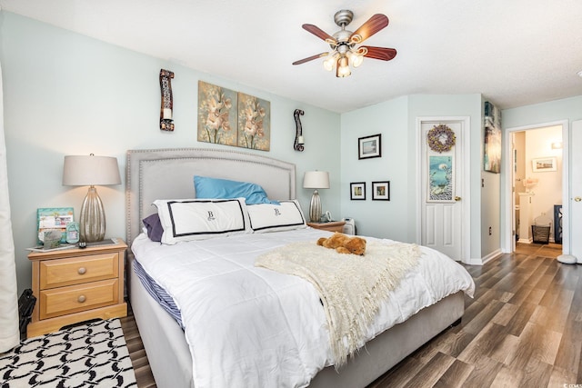 bedroom featuring ceiling fan, dark hardwood / wood-style flooring, and ensuite bath