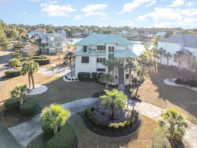 exterior space with a water view and a front lawn