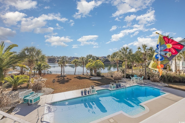 view of pool with a water view and a patio area