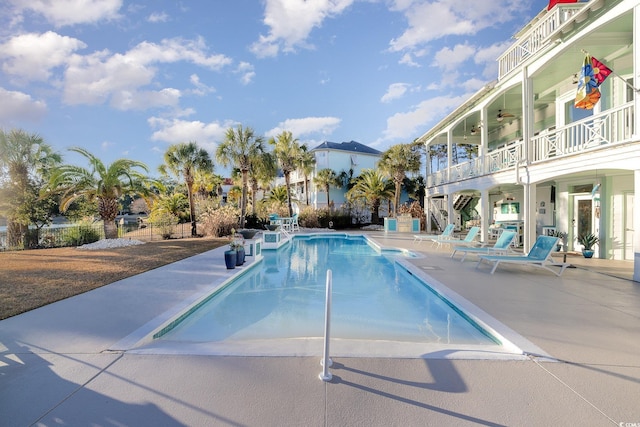 view of pool with ceiling fan and a patio