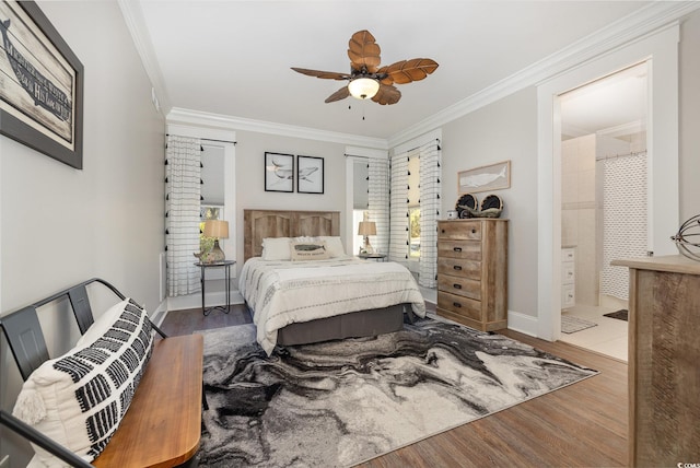 bedroom featuring hardwood / wood-style floors, ceiling fan, crown molding, and connected bathroom