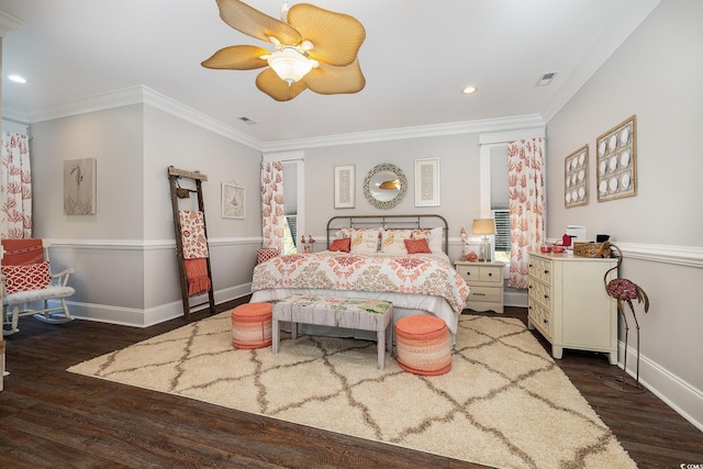 bedroom with dark hardwood / wood-style floors, ceiling fan, and crown molding