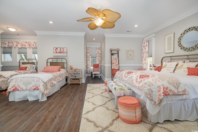 bedroom with ceiling fan, ornamental molding, and dark wood-type flooring