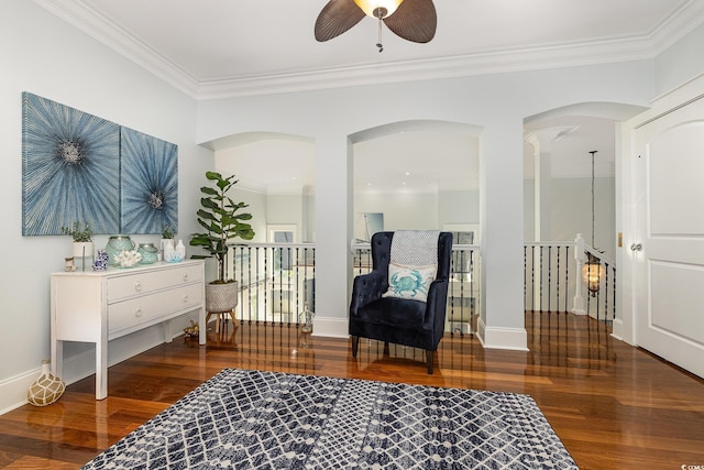 sitting room with dark hardwood / wood-style flooring, ceiling fan, and ornamental molding