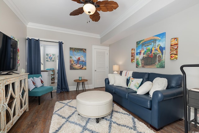 living room with dark hardwood / wood-style flooring, ceiling fan, and crown molding