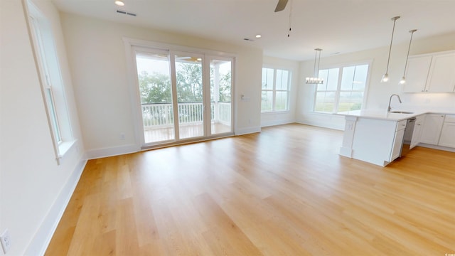 48 Furman Ln, Pawleys Island, SC 29585 - kitchen with light wood-style flooring, a peninsula, plenty of natural light, a ceiling fan, and recessed lighting