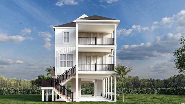 coastal home featuring a balcony and a front yard