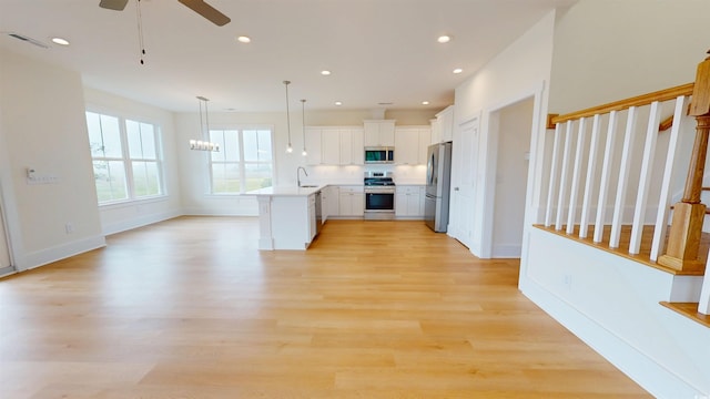 48 Furman Ln, Pawleys Island, SC 29585 - kitchen with stainless steel appliances, light wood-style flooring, open floor plan, recessed lighting, and light countertops