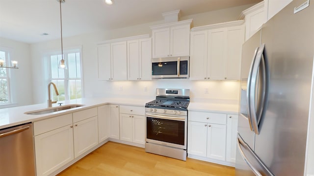 48 Furman Ln, Pawleys Island, SC 29585 - kitchen with appliances with stainless steel finishes, light wood-style floors, white cabinetry, light countertops, and recessed lighting