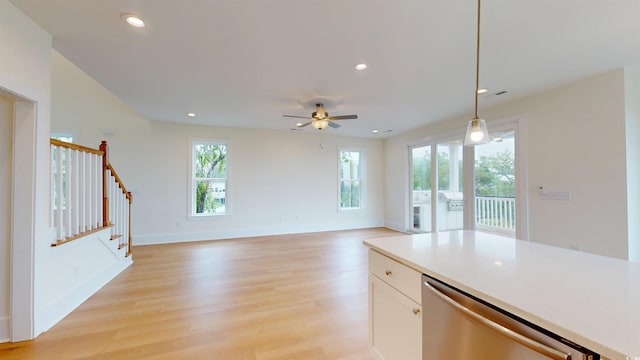 48 Furman Ln, Pawleys Island, SC 29585 - kitchen with stainless steel dishwasher, a ceiling fan, hanging light fixtures, white cabinetry, and light wood-type flooring
