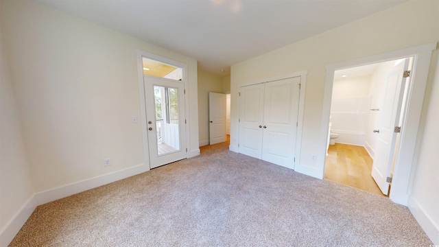 48 Furman Ln, Pawleys Island, SC 29585 - unfurnished bedroom with light carpet, connected bathroom, and a closet
