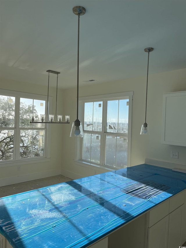 kitchen with pendant lighting and white cabinetry