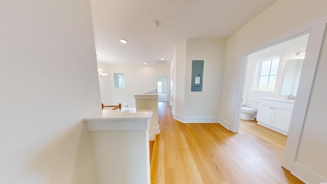 48 Furman Ln, Pawleys Island, SC 29585 - corridor with an upstairs landing, electric panel, light wood-style flooring, a chandelier, and recessed lighting