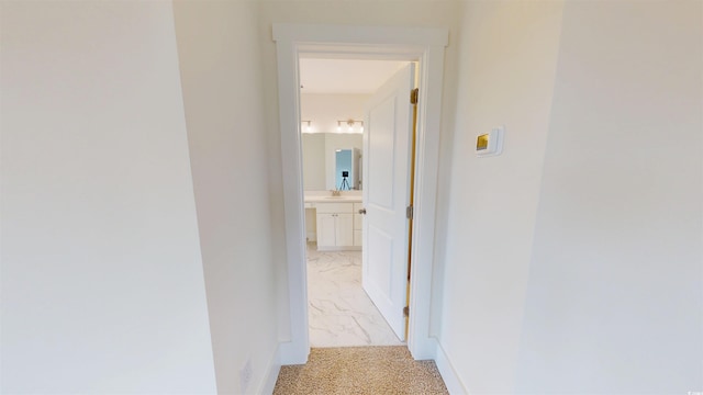48 Furman Ln, Pawleys Island, SC 29585 - hallway featuring light marble finish floors and a sink
