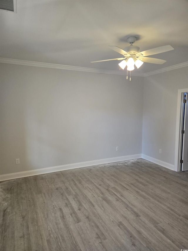 spare room with hardwood / wood-style floors, ornamental molding, and ceiling fan