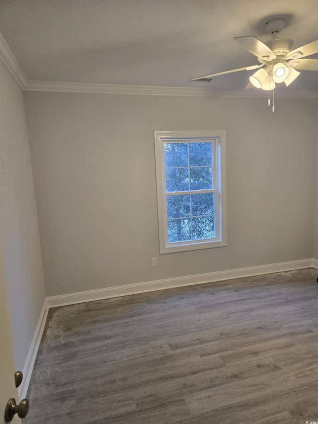 spare room with crown molding, ceiling fan, and dark hardwood / wood-style floors