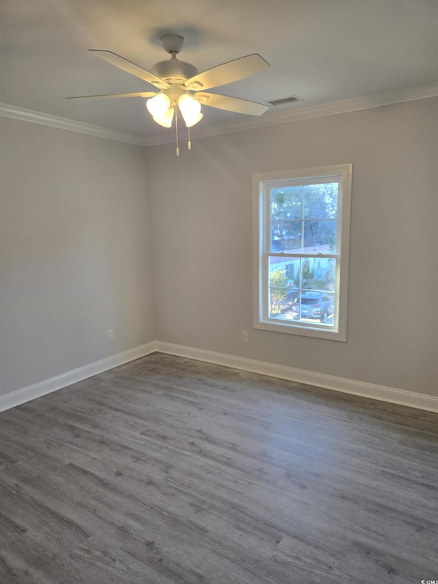 empty room with hardwood / wood-style flooring, ornamental molding, and ceiling fan