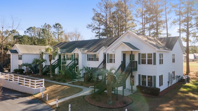 view of front of house featuring a front yard and central AC unit