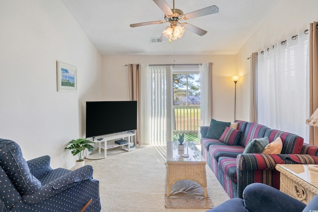 carpeted living room with ceiling fan, lofted ceiling, and a textured ceiling