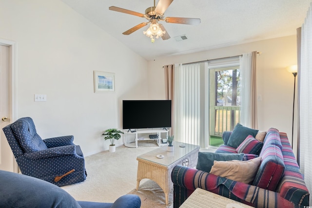 carpeted living room featuring ceiling fan and vaulted ceiling