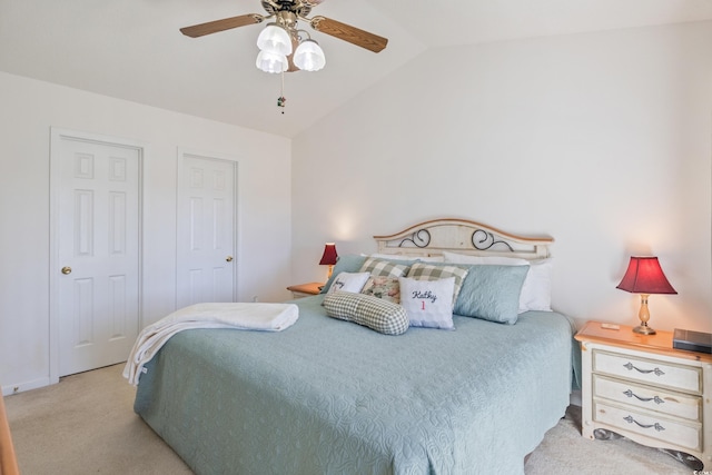 carpeted bedroom with ceiling fan and lofted ceiling