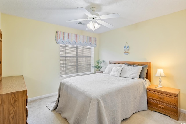 bedroom with light carpet and ceiling fan