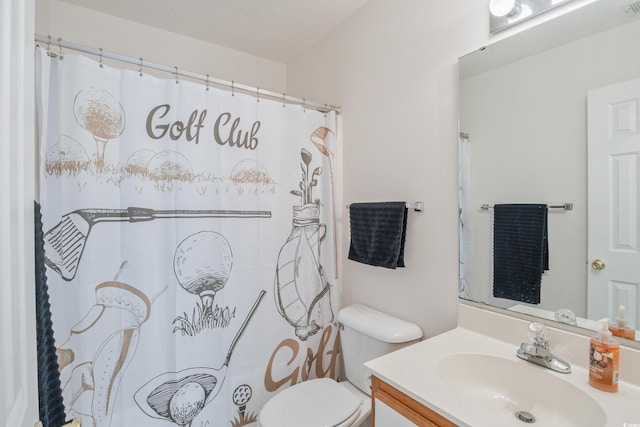 bathroom with vanity, a textured ceiling, and toilet