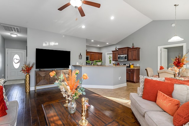 living room featuring vaulted ceiling, ceiling fan, and dark hardwood / wood-style floors