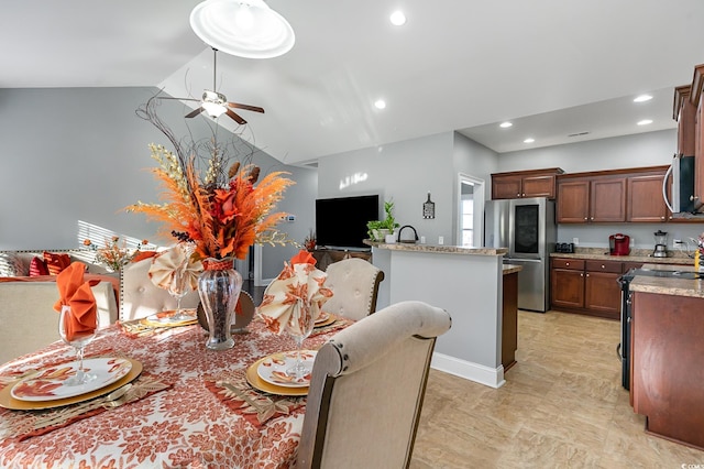 dining room featuring ceiling fan and vaulted ceiling