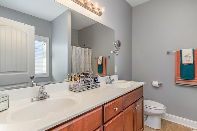 bathroom with curtained shower, vanity, and toilet